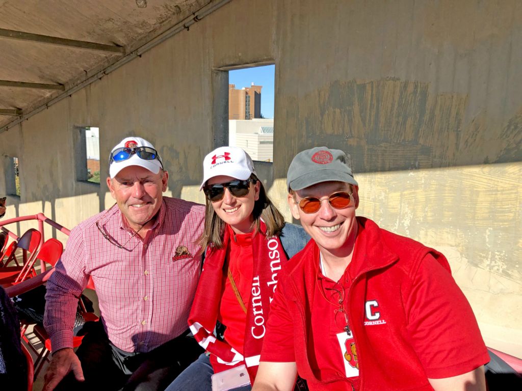 Rick Turner '77, Lauren Turner '13, MBA '21 and Mark Nelson, Dean, Cornell SC Johnson College of Business, watch the Big Red take on Georgetown.